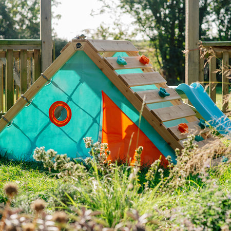 Plum Play's My First Wooden Playcentre installed in a garden