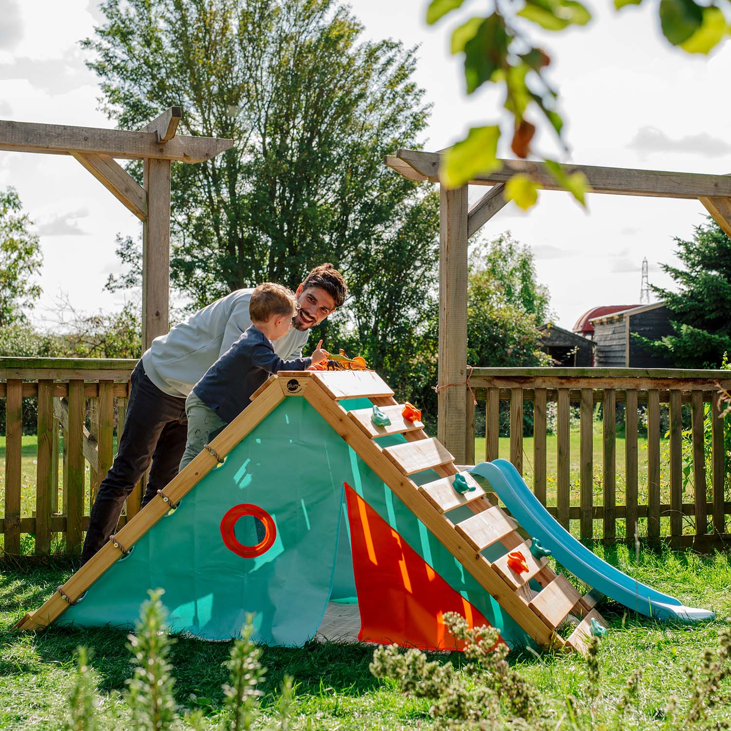 Dad and son playing on the Plum Play's My First Wooden Playcentre