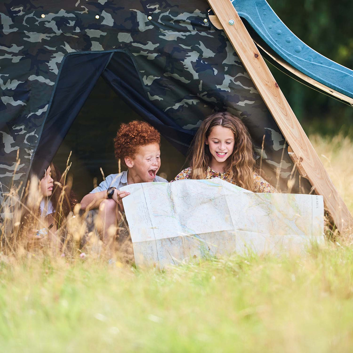 Children playing in the den area of Plum Play's Climbing Pyramid