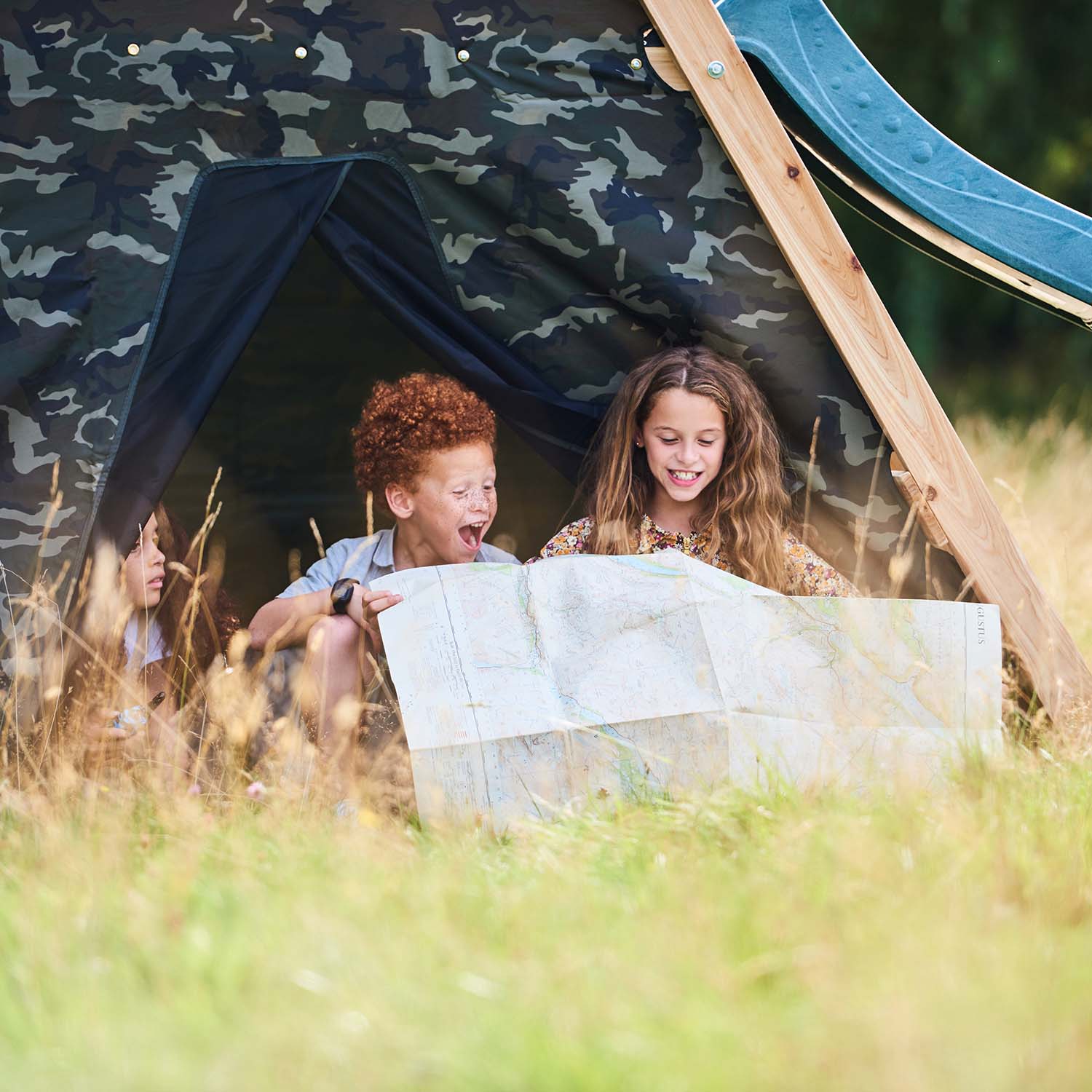Children playing in the den area of Plum Play's Climbing Pyramid