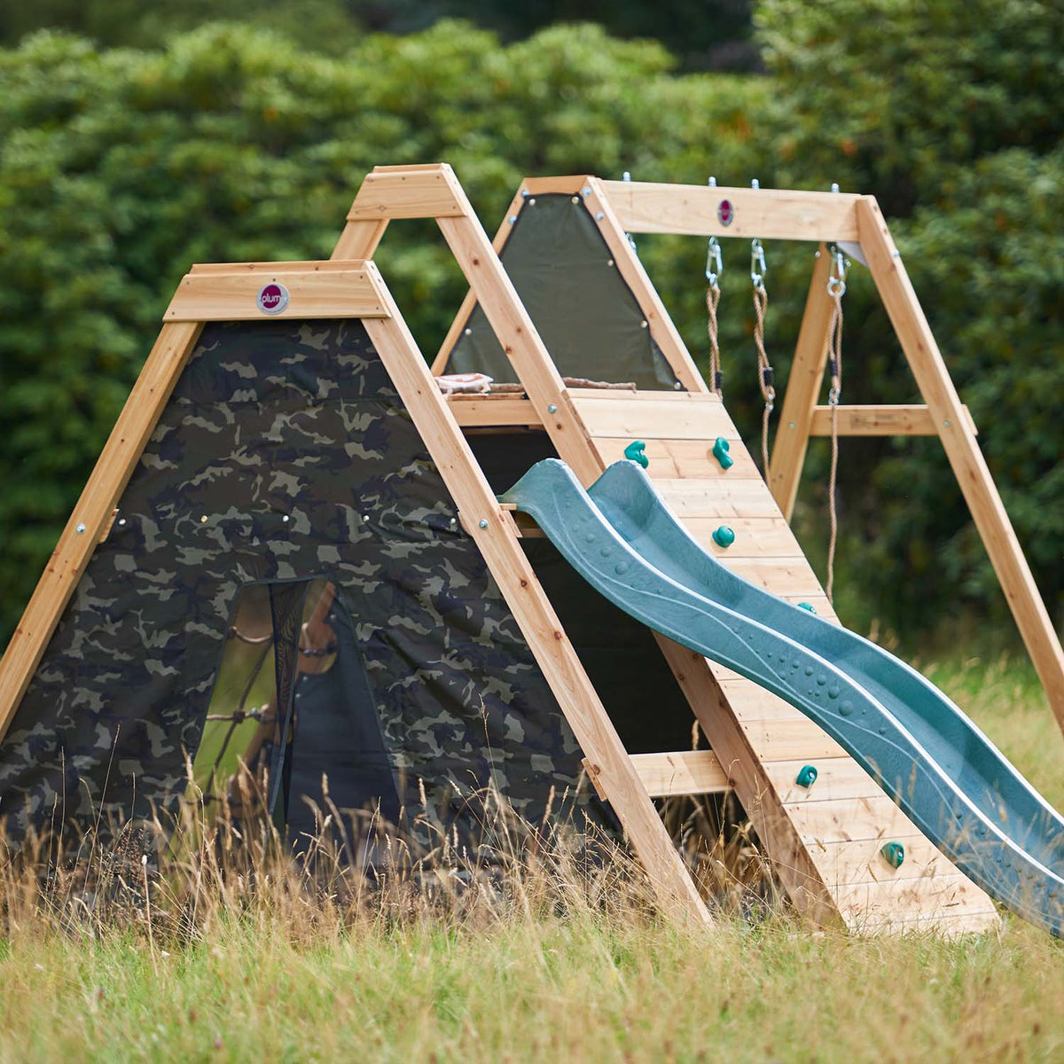 Ring angle view of Plum Play's Climbing Pyramid Wooden Climbing Frame with Swings installed in a lawn