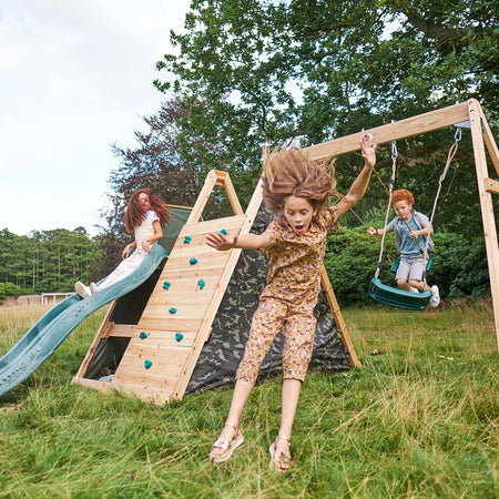 Children playing in the Plum Play's Climbing Pyramid Wooden Climbing Frame with Swings