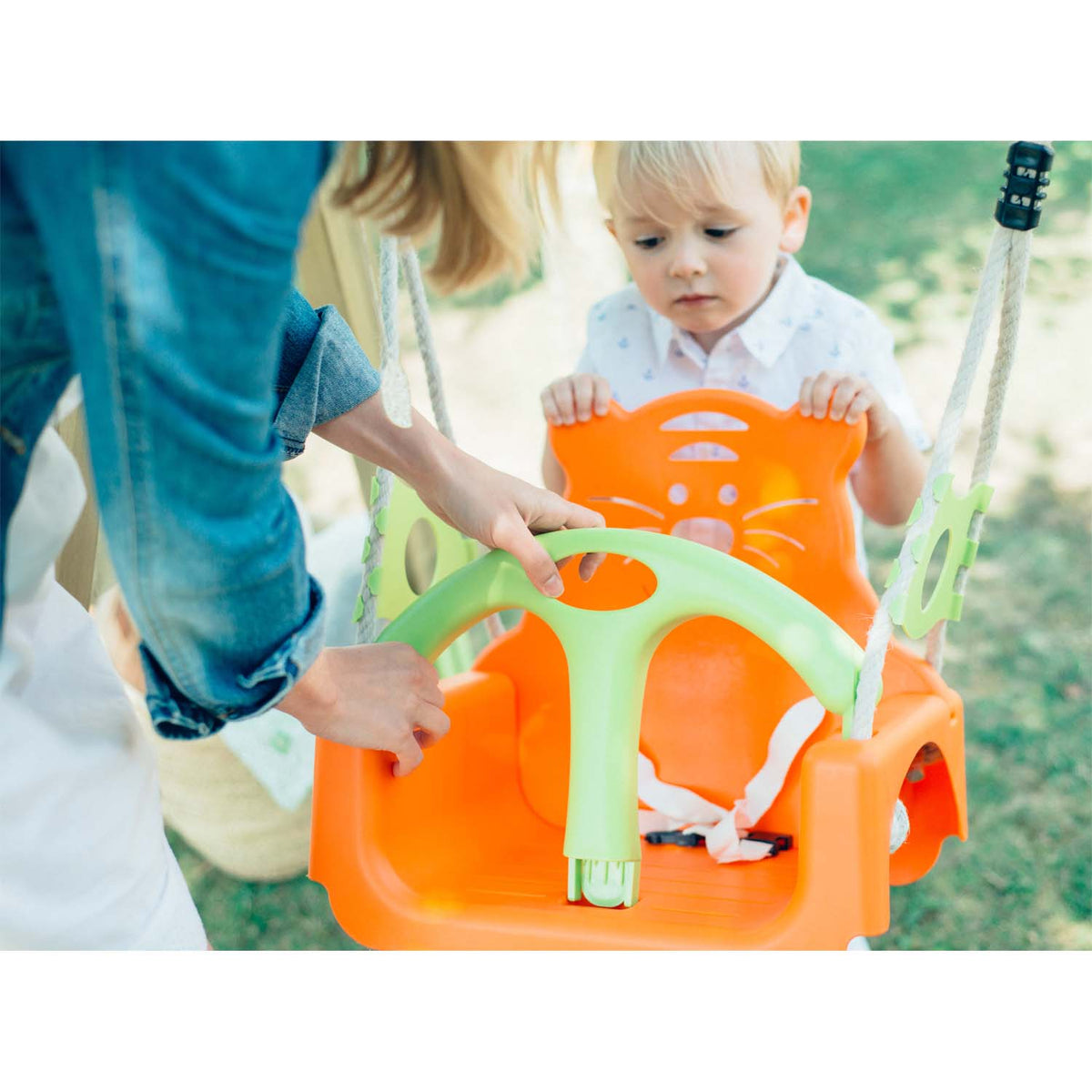 Toddler and guardian playing in Plum Play's Wooden Growing Swing Set