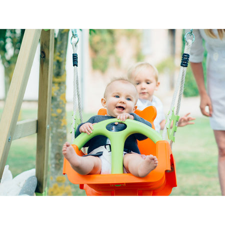 Children playing in Plum Play's 3-in-1 Wooden Growing Swing Set