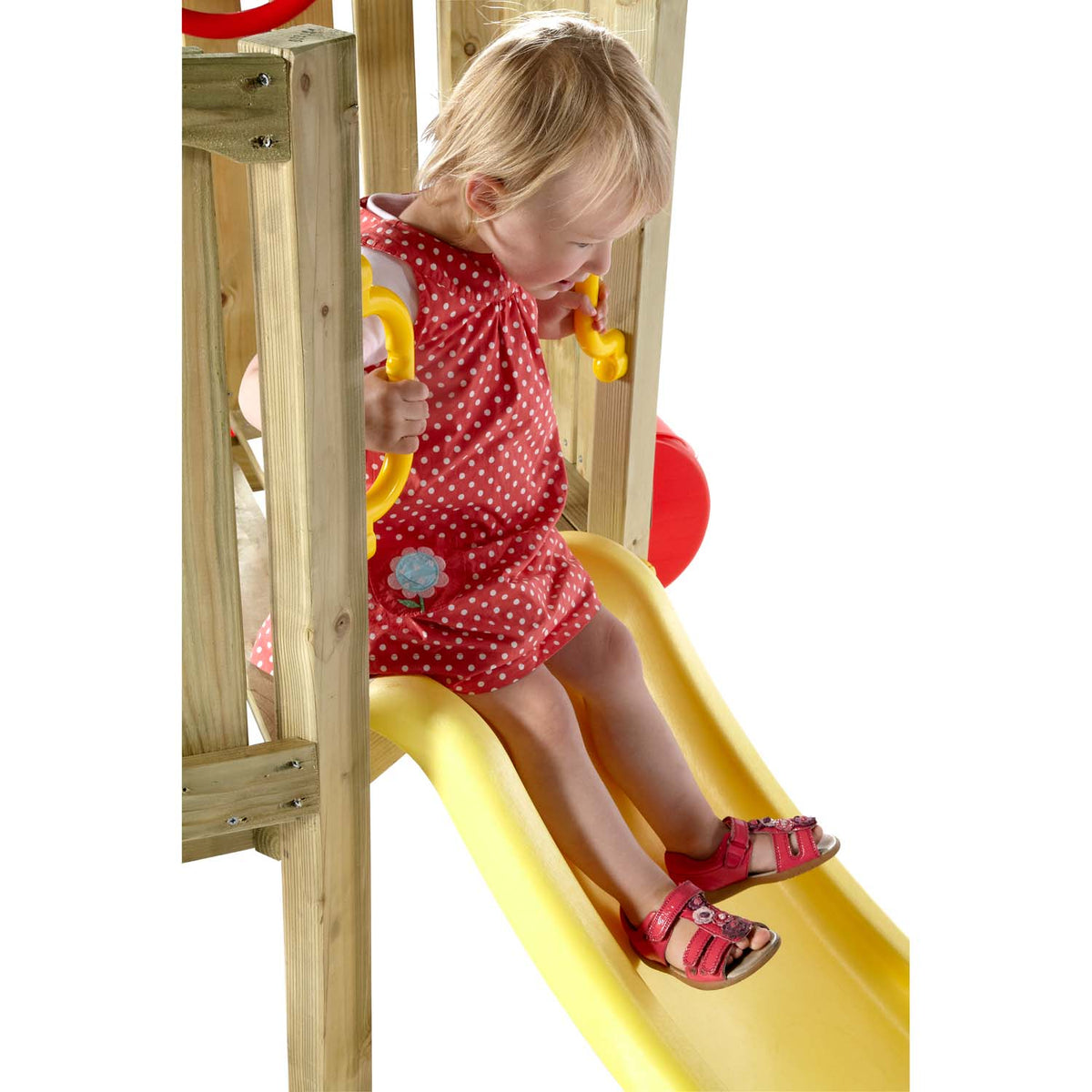 A toddler sitting at the top of slide in Plum Play's Toddlers Tower Wooden Climbing Frame