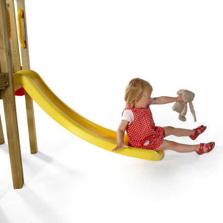 A baby girl holding a plushie and sitting at the end of the slide in Plum Play's Toddlers Tower Wooden Climbing Frame