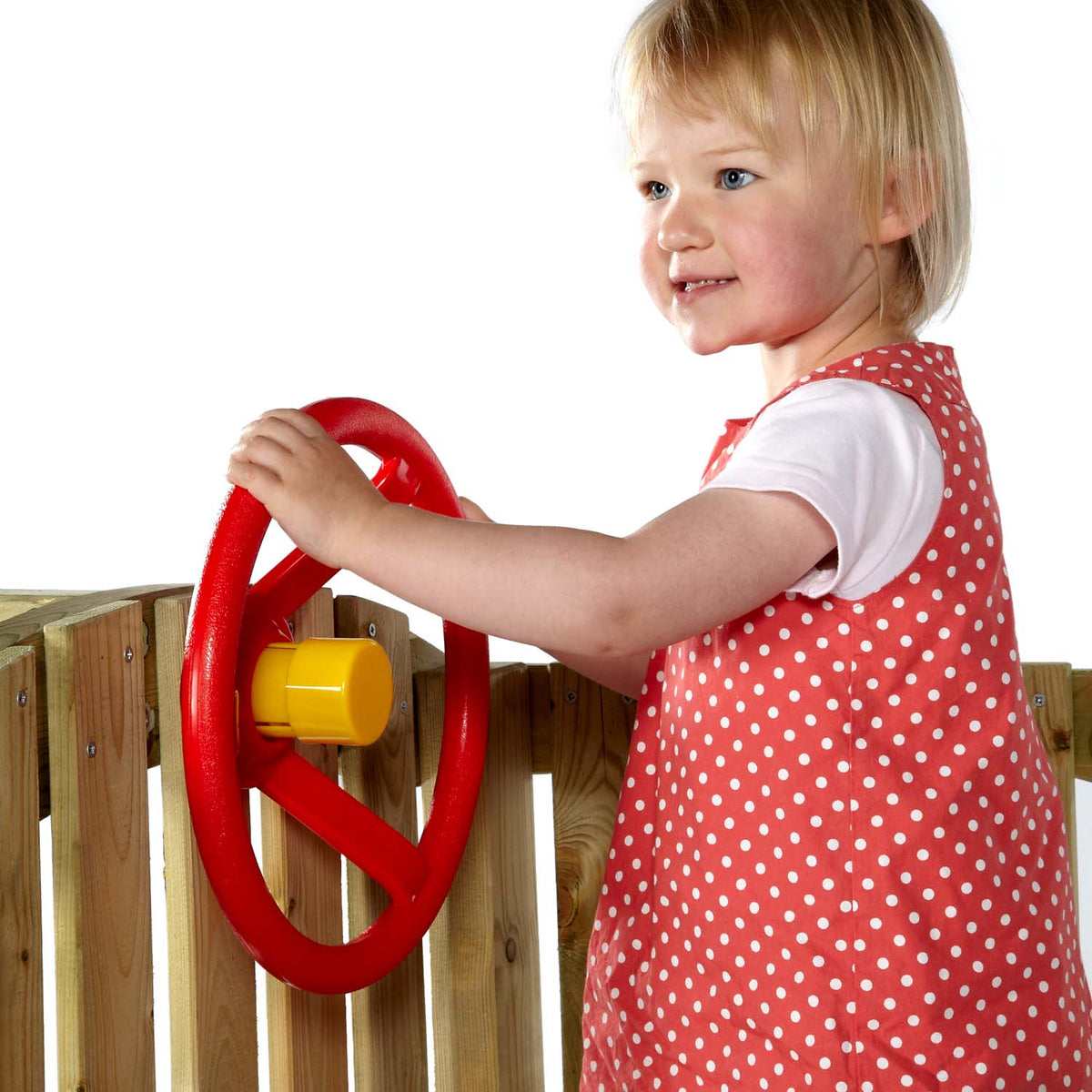 A girl holding the steering wheel accessory in Plum Play's Toddlers Tower Wooden Climbing Frame