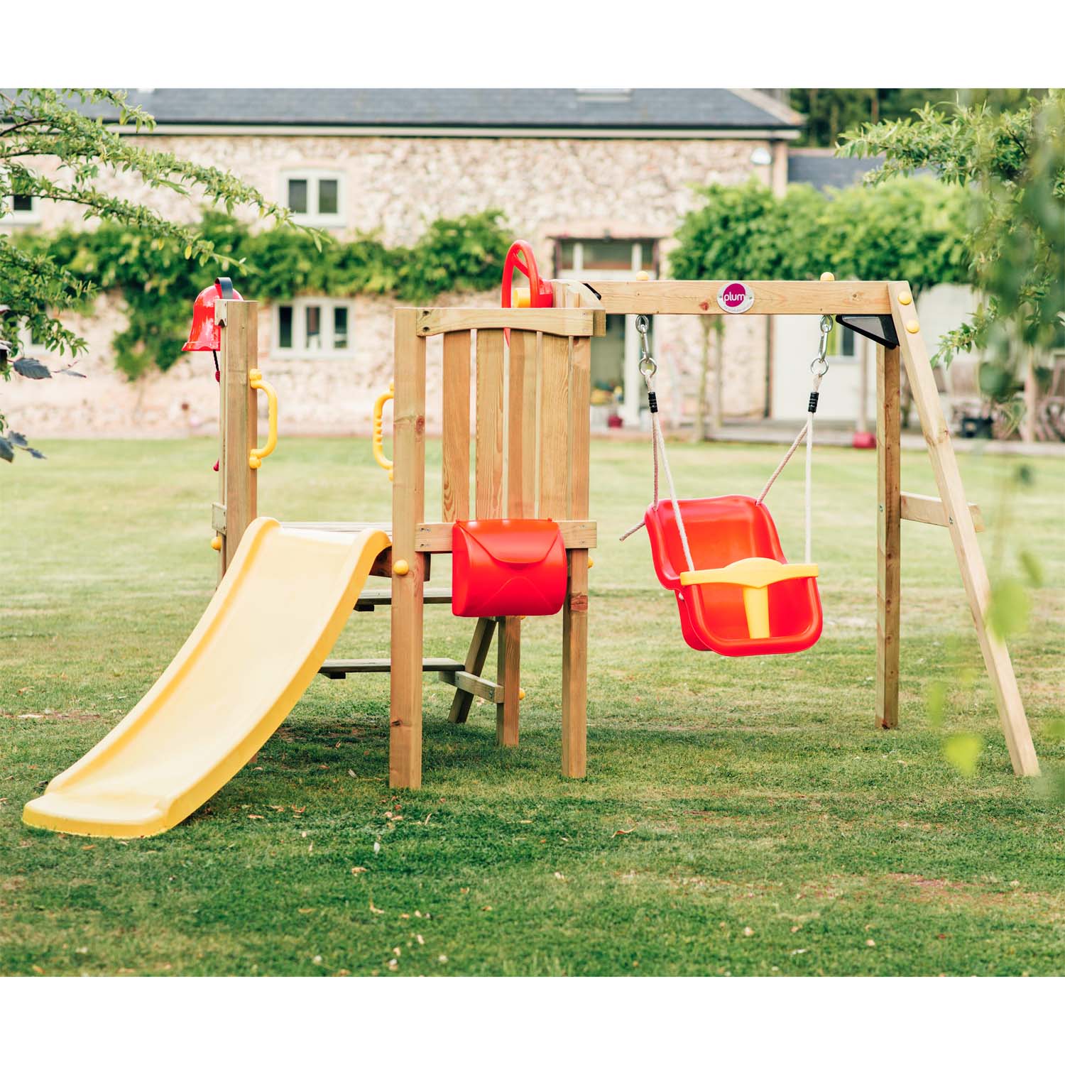Plum Play's Toddlers Tower Wooden Climbing Frame in a garden lawn