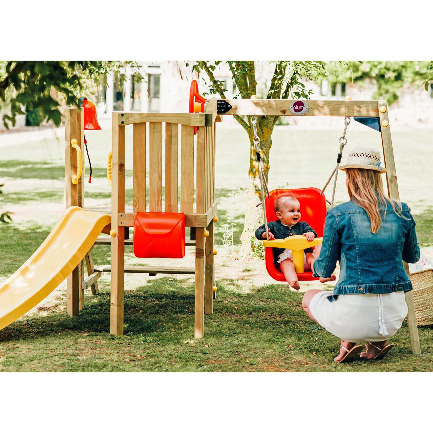 An infant and a mom playing in Plum Play's Toddlers Tower Wooden Climbing Frame