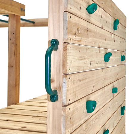 Rock wall with colored hand and foot grips in Plum Play's Wooden Climbing Cube XL