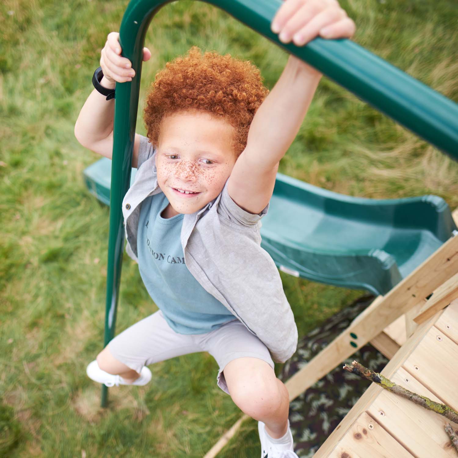 Boy sliding down using the 2.5 metre fireman's pole in Plum Play's Wooden Climbing Cube XL