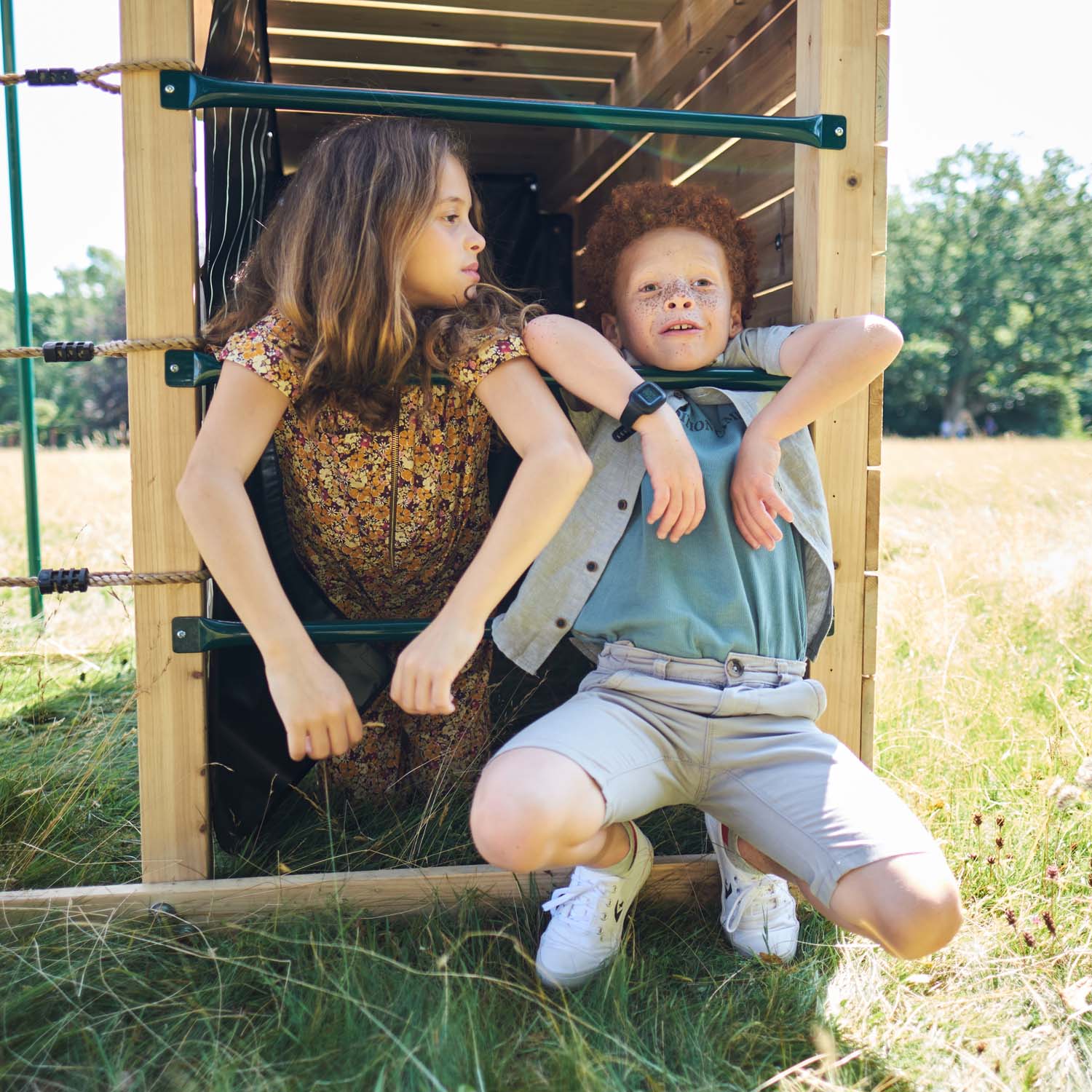 Two children playing in the den area of Plum Play's Wooden Climbing Cube XL