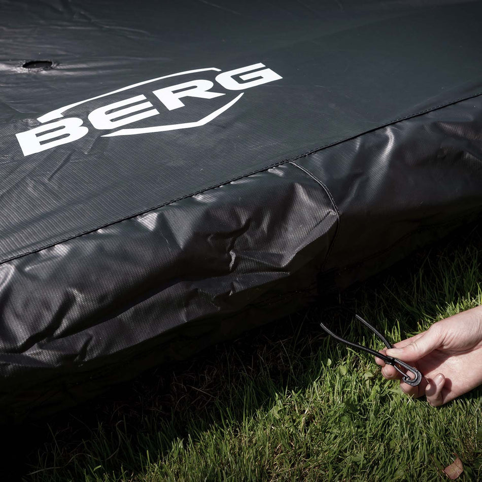 Close-up photo of BERG Trampoline Weather Cover in black with white logo