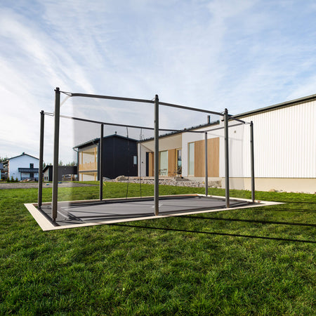 Acon HD Trampoline seamlessly integrated into residential backyard landscaping with professional flush-mount installation, showing aesthetic and functional benefits of in-ground placement.