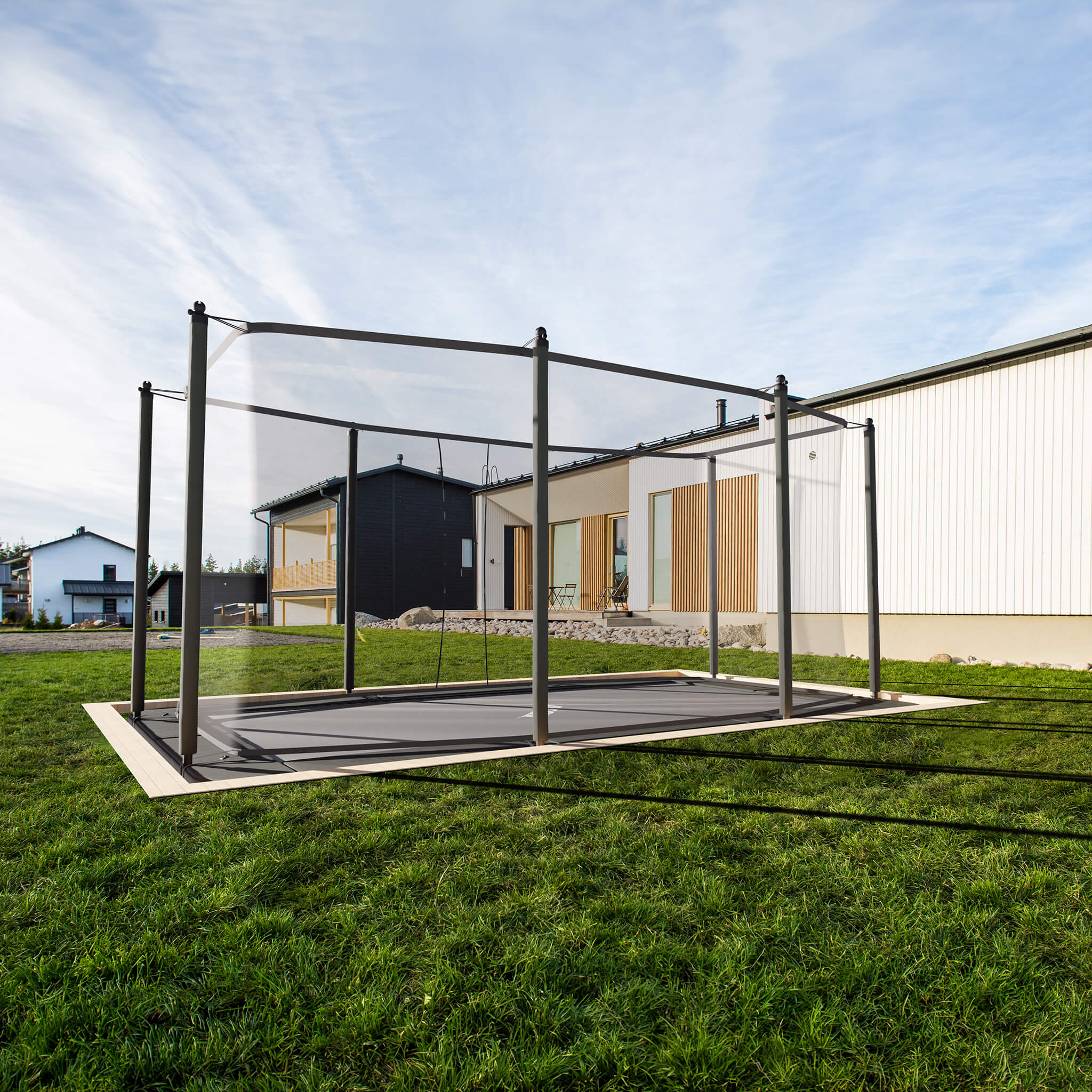 Acon HD Trampoline professionally installed at ground level within residential garden setting, demonstrating seamless landscape integration and aesthetic appeal of flush-mount installation.