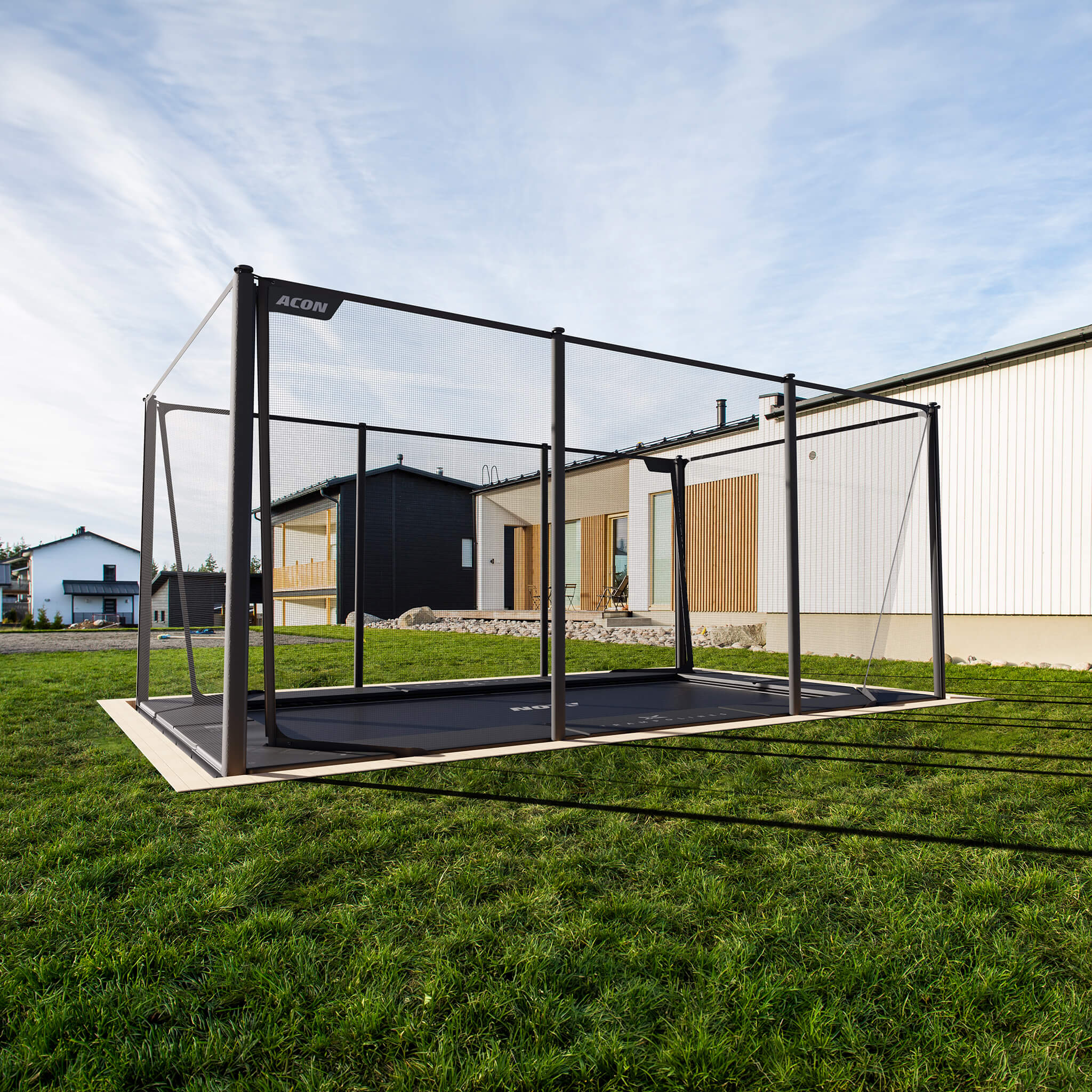 Acon X Trampoline installed flush with ground level in residential backyard setting, demonstrating professional in-ground installation option for seamless landscape integration.