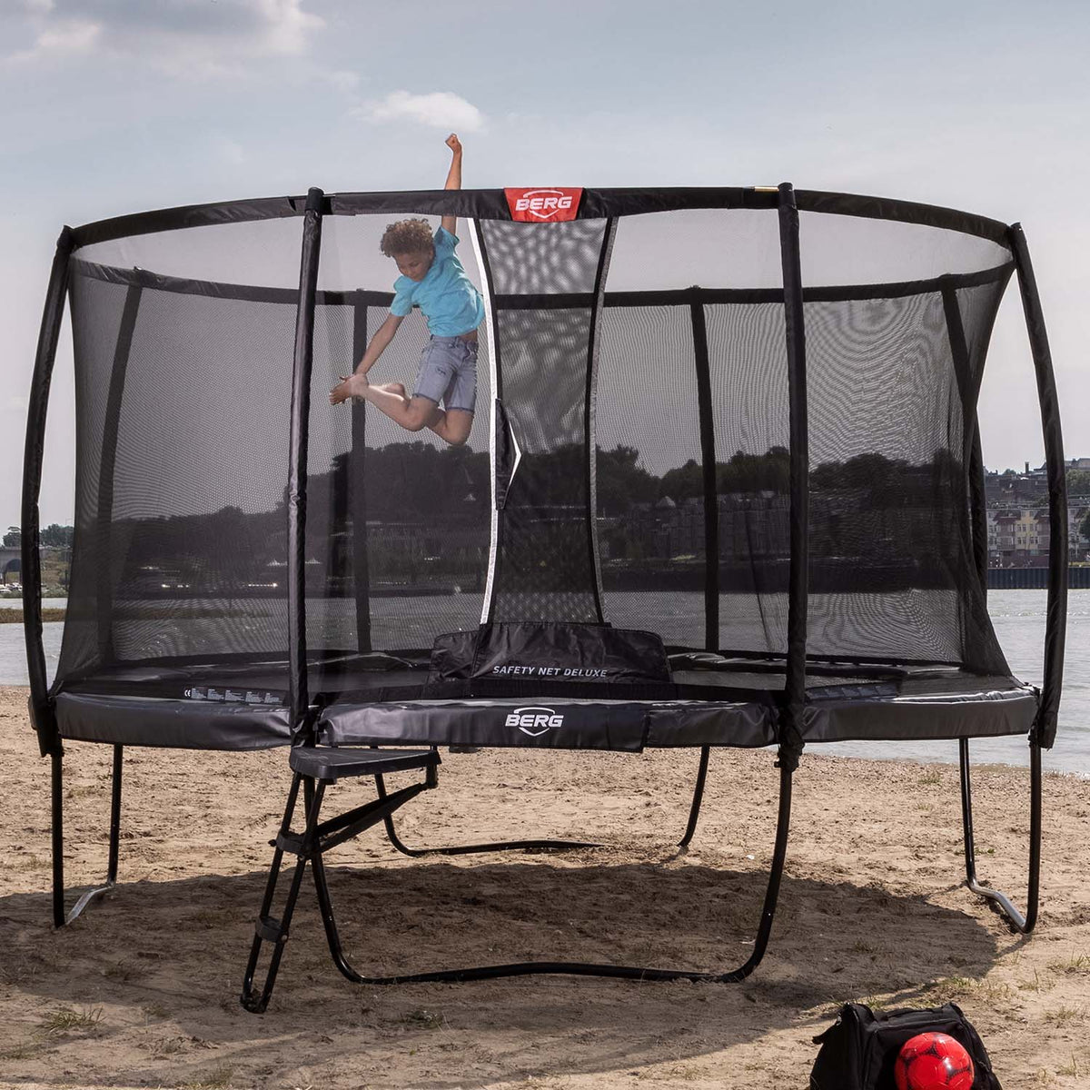 A child playing on a BERG Elite Trampoline with Ladder