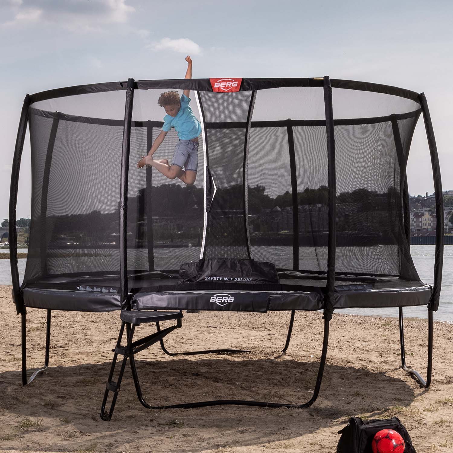 A child playing on a BERG Elite Trampoline with Ladder