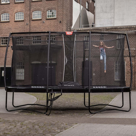 A young girl jumping on a BERG Elite Trampoline with Ladder
