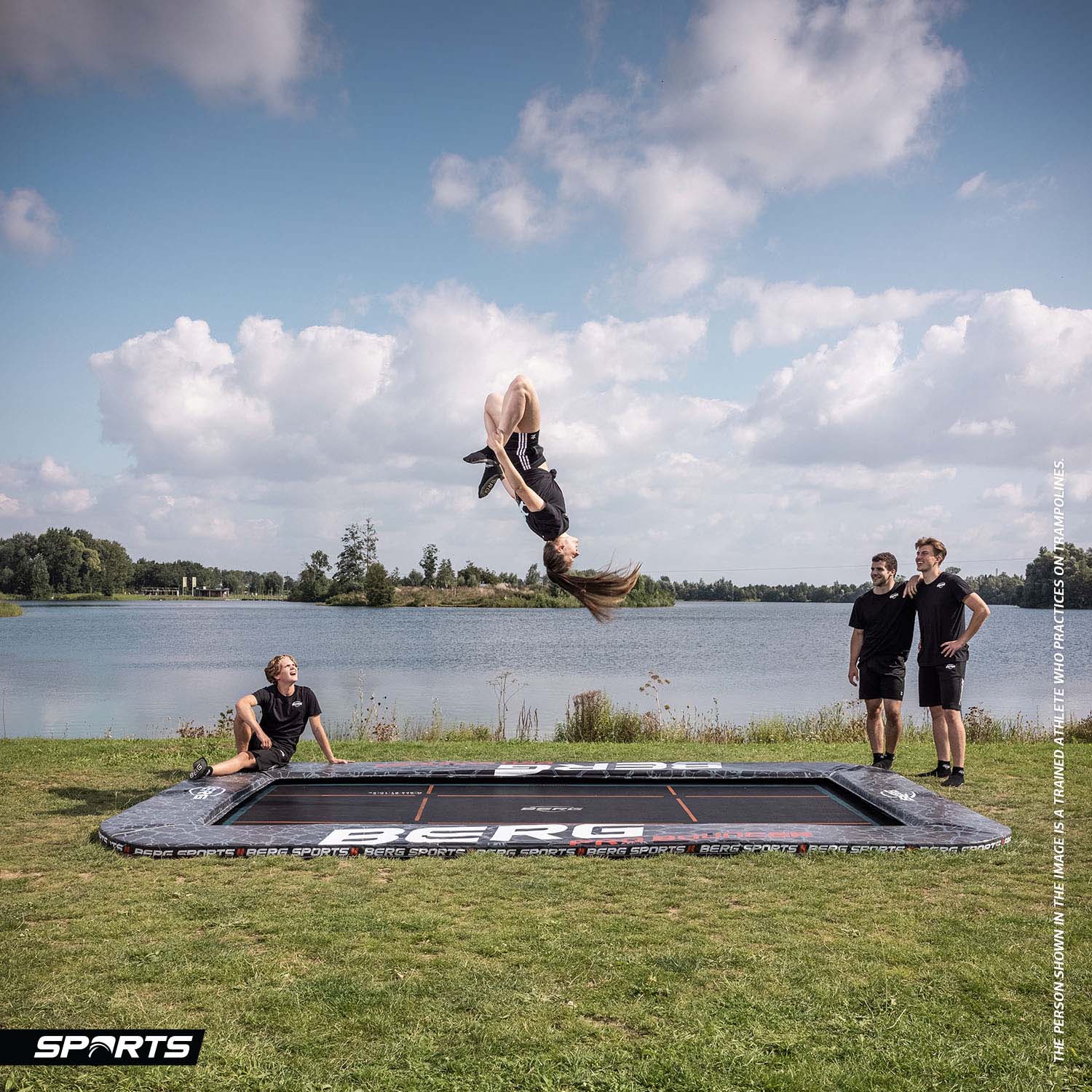 trained athletes practicing somersault exercise on a BERG SPORTS Ultim Pro Bouncer FlatGround Rectangular Trampoline