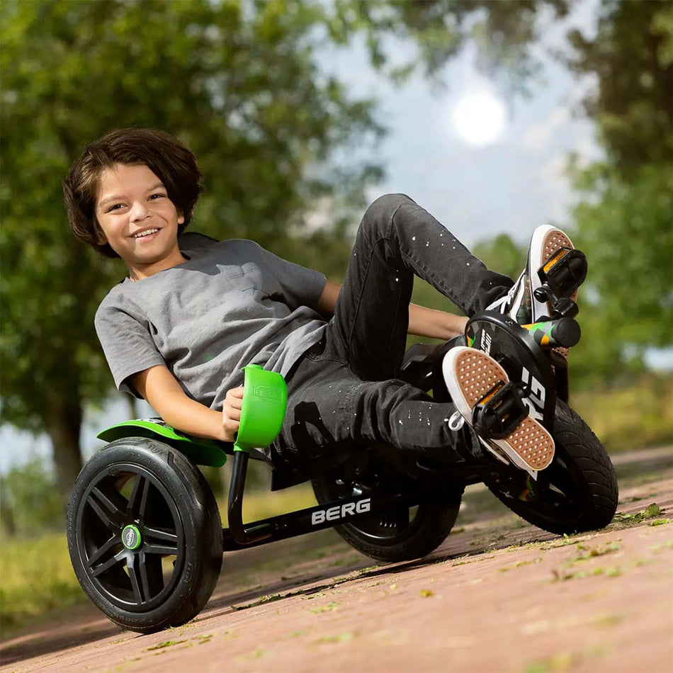 Boy smiling while riding a BERG Street-X Venom Pedal Go-Kart in Green colour