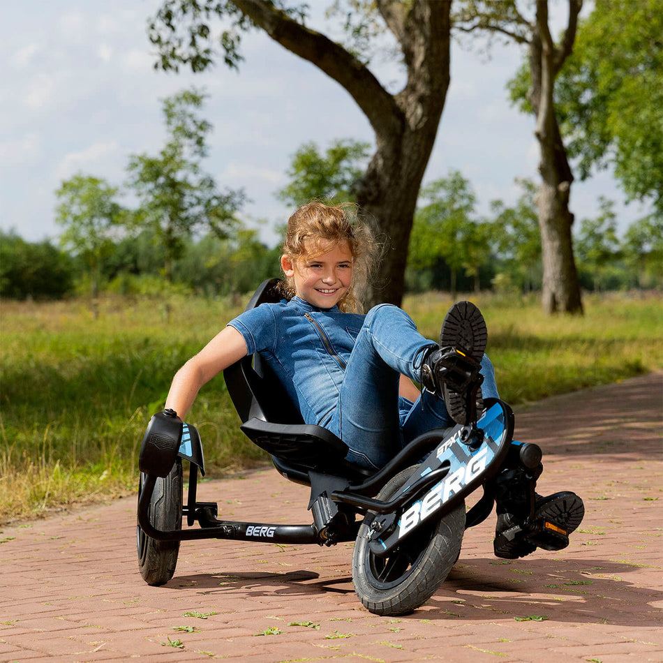 Girl smiling happily while riding in BERG Street-X Vibes Pedal Go-Kart