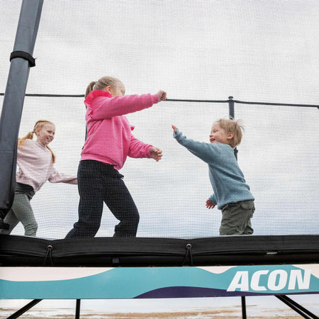 Multiple children engaged in group play activities on the Acon X Trampoline, illustrating the social benefits and shared enjoyment of quality outdoor recreation equipment.